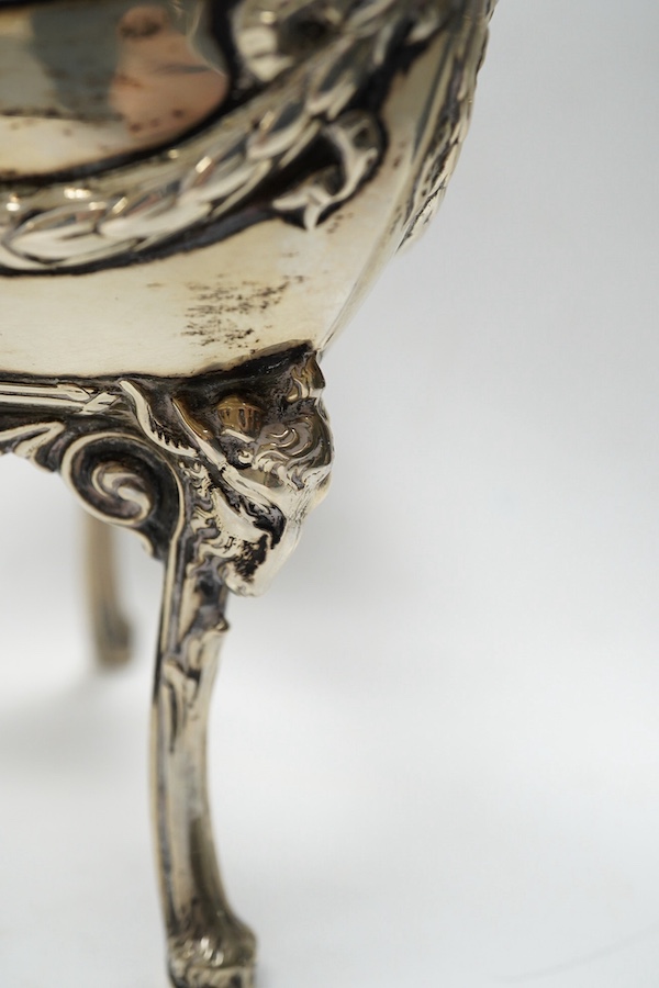 An Edwardian silver vase, embossed with hunting scene, with blue glass liner, Manoah Rhodes & Sons Ltd, London, 1901, 20.7cm, together with a German 800 white metal dish, on three supports. with damaged glass liner, 14.4